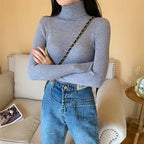 Women's ribbed knit turtleneck sweater, fitted with long sleeves